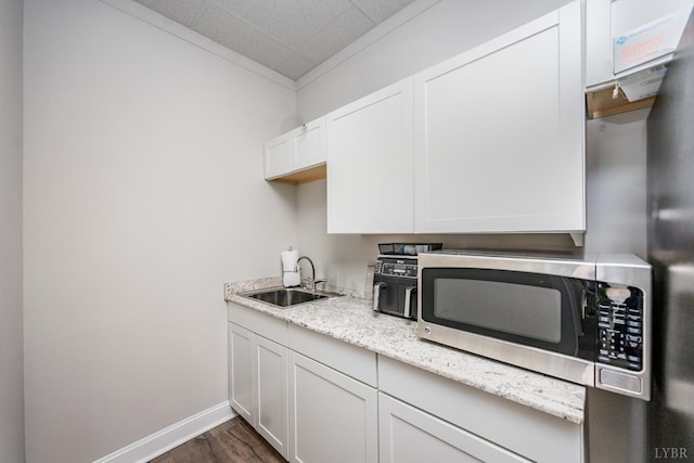 1313 Enterprise, Lynchburg, VA 24502 - kitchen with stainless steel microwave, dark wood-type flooring, white cabinetry, light stone countertops, and ornamental molding