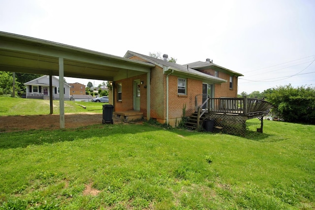 315 Cork St, Lynchburg, VA 24503 - rear view of property with a lawn, brick siding, a wooden deck, and a carport