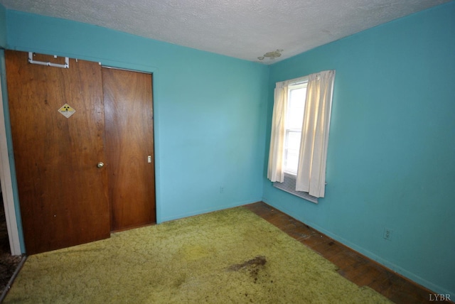 315 Cork St, Lynchburg, VA 24503 - unfurnished bedroom with a textured ceiling, a closet, and carpet flooring