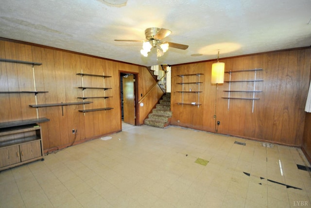 315 Cork St, Lynchburg, VA 24503 - unfurnished living room with wood walls, stairs, a ceiling fan, tile patterned floors, and crown molding