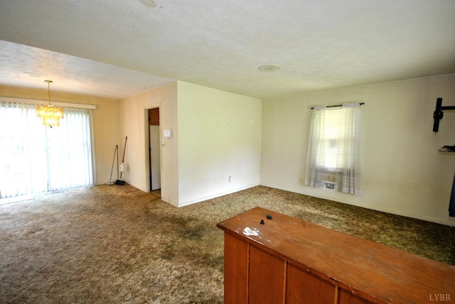 315 Cork St, Lynchburg, VA 24503 - unfurnished living room featuring dark carpet and a chandelier