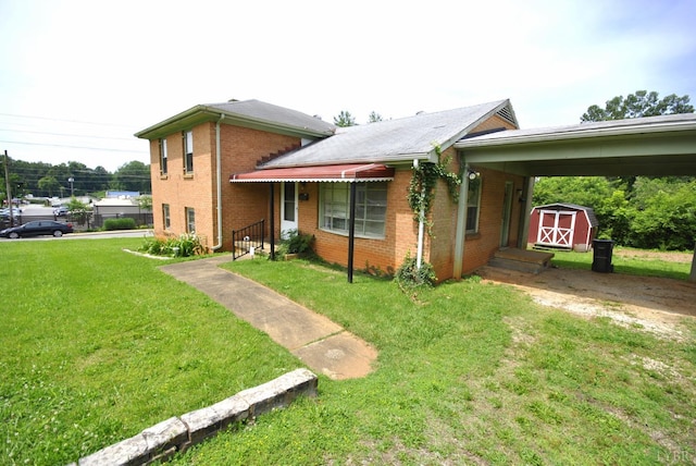 315 Cork St, Lynchburg, VA 24503 - view of front of home with a storage unit, a front yard, brick siding, and an attached carport