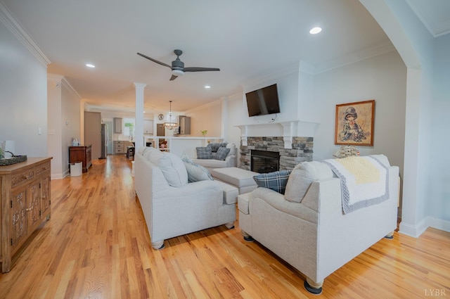 1507 Helmsdale Dr, Forest, VA 24551 - living area with crown molding, a ceiling fan, light wood-style flooring, a fireplace, and arched walkways