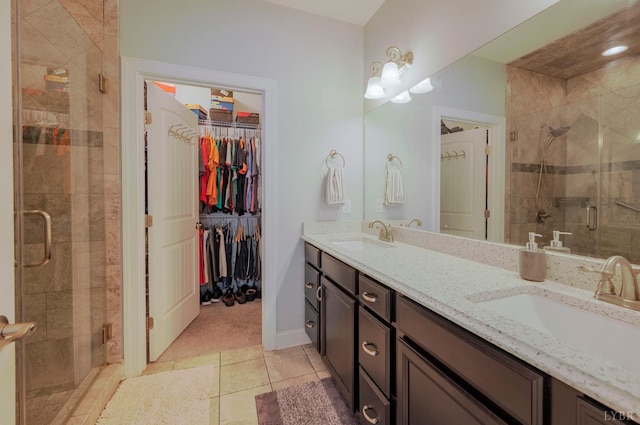 1507 Helmsdale Dr, Forest, VA 24551 - full bathroom featuring a shower stall, double vanity, tile patterned flooring, and a spacious closet