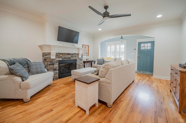 1507 Helmsdale Dr, Forest, VA 24551 - living room featuring ceiling fan, arched walkways, light wood-type flooring, ornamental molding, and a fireplace