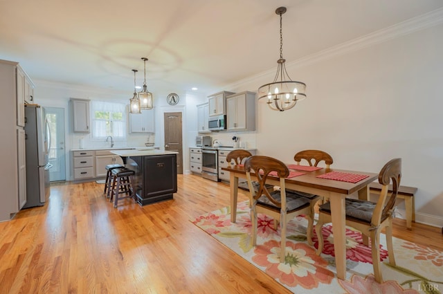 1507 Helmsdale Dr, Forest, VA 24551 - dining area with ornamental molding, a chandelier, and light wood-type flooring