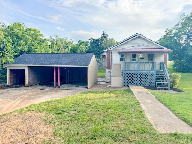 1033 8th St, Altavista, VA 24517 - bungalow with a front lawn, a porch, a carport, stairs, and an outbuilding