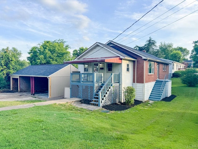 1033 8th St, Altavista, VA 24517 - view of front of property with a front yard, an outbuilding, driveway, brick siding, and stairs
