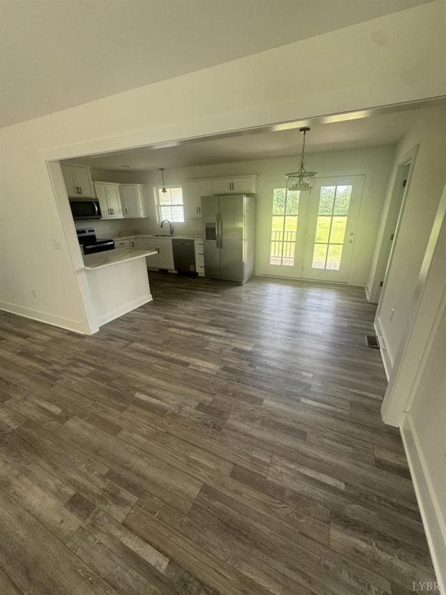 601 Mockingbird Ln, Gladstone, VA 24553 - unfurnished living room with dark wood-style floors and a chandelier