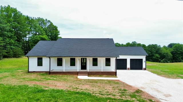 601 Mockingbird Ln, Gladstone, VA 24553 - modern farmhouse with covered porch, an attached garage, driveway, a front lawn, and roof with shingles