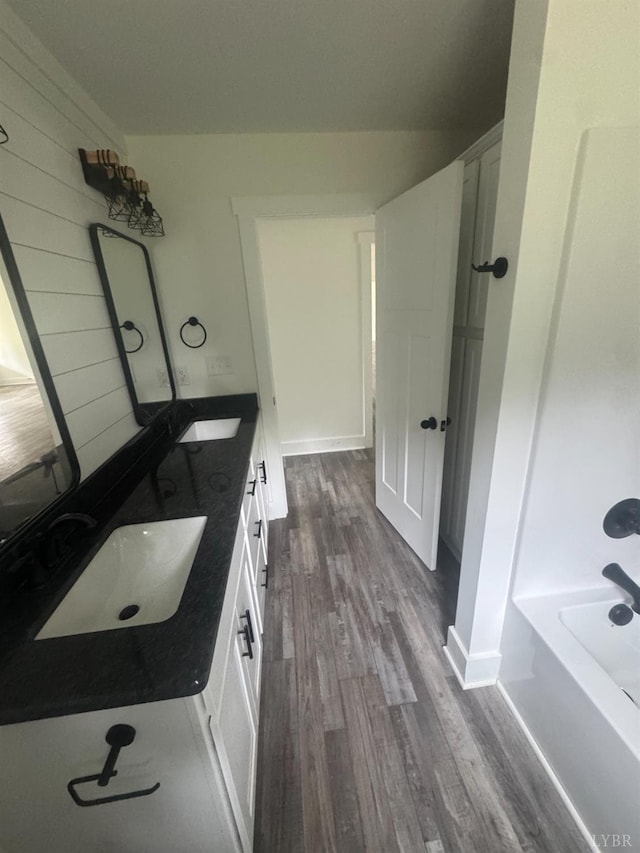 601 Mockingbird Ln, Gladstone, VA 24553 - full bathroom featuring wood finished floors and double vanity
