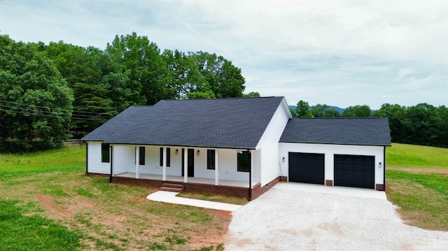 601 Mockingbird Ln, Gladstone, VA 24553 - view of front of house with covered porch, a garage, driveway, roof with shingles, and a front yard