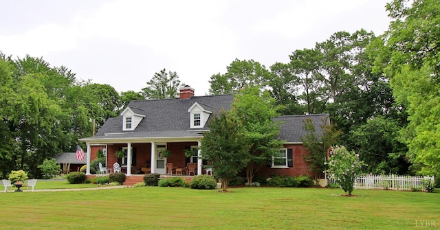 1538 Redfields Rd, Appomattox, VA 24522 - cape cod home with covered porch, brick siding, a chimney, and view of scattered trees