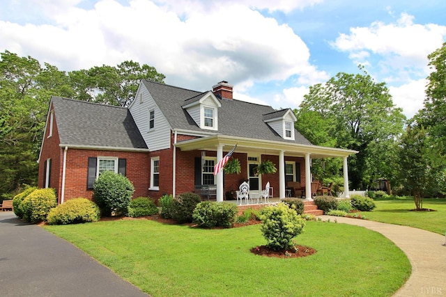 1538 Redfields Rd, Appomattox, VA 24522 - cape cod house with brick siding, a chimney, a porch, and a front lawn