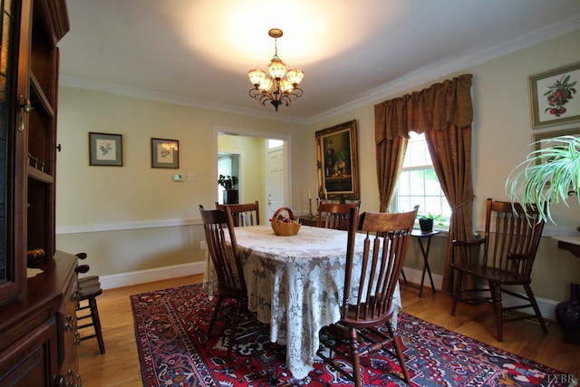 1538 Redfields Rd, Appomattox, VA 24522 - dining space with light wood finished floors, crown molding, and a chandelier