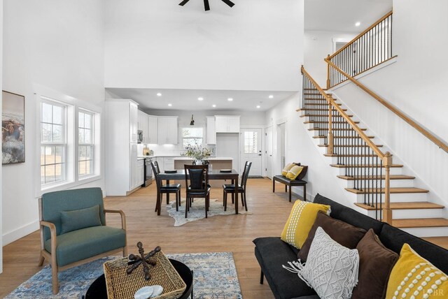 128 Riverside Dr, Lynchburg, VA 24503 - living area featuring a towering ceiling, stairway, light wood-style floors, a ceiling fan, and recessed lighting