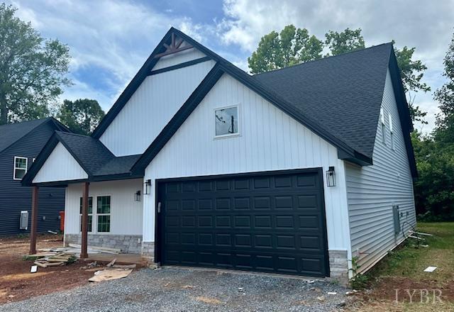 128 Riverside Dr, Lynchburg, VA 24503 - modern farmhouse style home featuring a shingled roof, driveway, and an attached garage