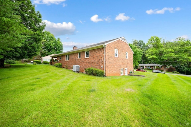 313 Robin Dr, Lynchburg, VA 24502 - back of house featuring a chimney, brick siding, and a lawn