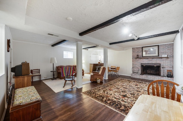 313 Robin Dr, Lynchburg, VA 24502 - living room with a textured ceiling, wood finished floors, a fireplace, and beamed ceiling
