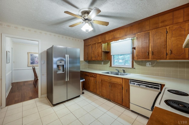 313 Robin Dr, Lynchburg, VA 24502 - kitchen featuring white appliances, light countertops, brown cabinetry, decorative backsplash, and ceiling fan