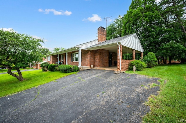 313 Robin Dr, Lynchburg, VA 24502 - ranch-style home with asphalt driveway, a chimney, a front yard, brick siding, and a carport