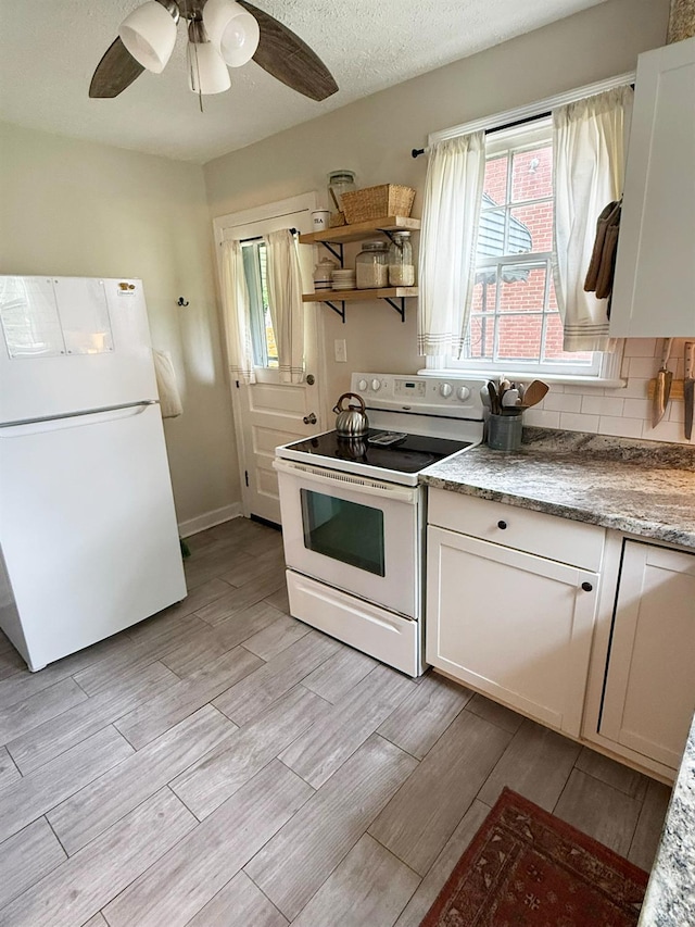 1309 Cherokee Ave, Lynchburg, VA 24502 - kitchen featuring white appliances, light wood-style flooring, healthy amount of natural light, and a ceiling fan