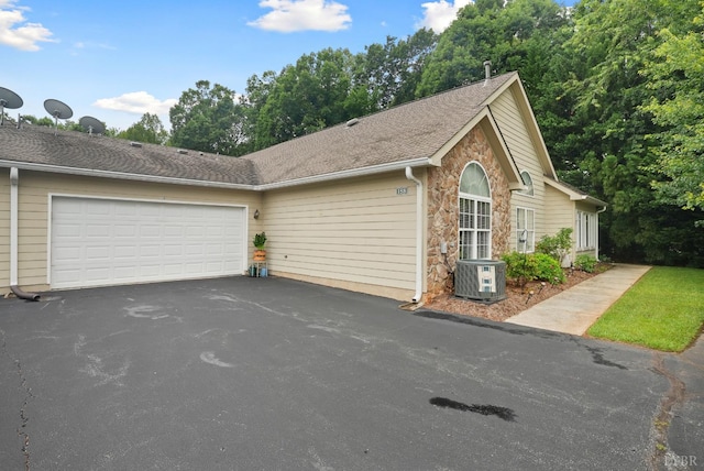 158 Salisbury Cir, Lynchburg, VA 24502 - view of front of house with driveway, a garage, stone siding, and roof with shingles