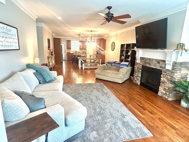 1481 Helmsdale Dr, Forest, VA 24551 - living area featuring ornamental molding, ceiling fan, wood finished floors, a fireplace, and a chandelier