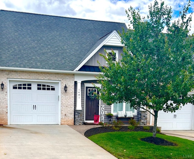 1481 Helmsdale Dr, Forest, VA 24551 - view of front of home with concrete driveway, board and batten siding, stone siding, an attached garage, and a shingled roof