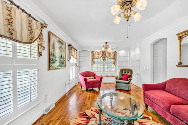 581 Ben Annie Rd, Gretna, VA 24557 - living area with wood finished floors, a ceiling fan, ornamental molding, arched walkways, and built in shelves