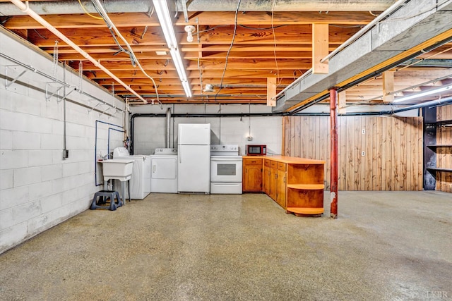 581 Ben Annie Rd, Gretna, VA 24557 - unfinished below grade area with washer and dryer, freestanding refrigerator, and concrete block wall