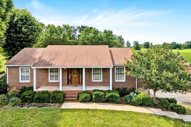 581 Ben Annie Rd, Gretna, VA 24557 - view of front of property with brick siding, a front lawn, covered porch, and a shingled roof