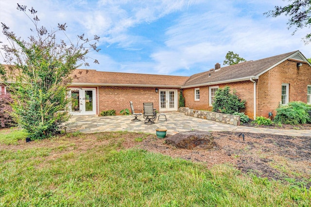 581 Ben Annie Rd, Gretna, VA 24557 - back of property featuring french doors, brick siding, a chimney, a patio area, and roof with shingles