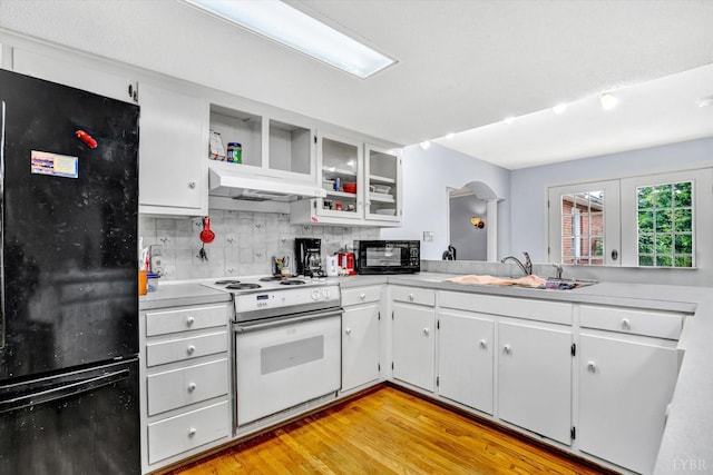 581 Ben Annie Rd, Gretna, VA 24557 - kitchen featuring black appliances, light countertops, arched walkways, backsplash, and under cabinet range hood
