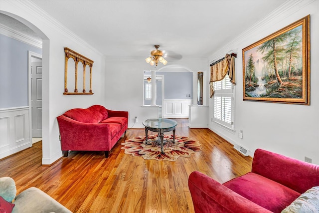 581 Ben Annie Rd, Gretna, VA 24557 - living area with wood finished floors, arched walkways, ornamental molding, and a wainscoted wall