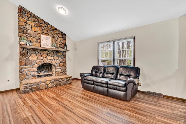 51 Laurel Ln, Lynchburg, VA 24502 - living area featuring lofted ceiling, wood finished floors, and a stone fireplace