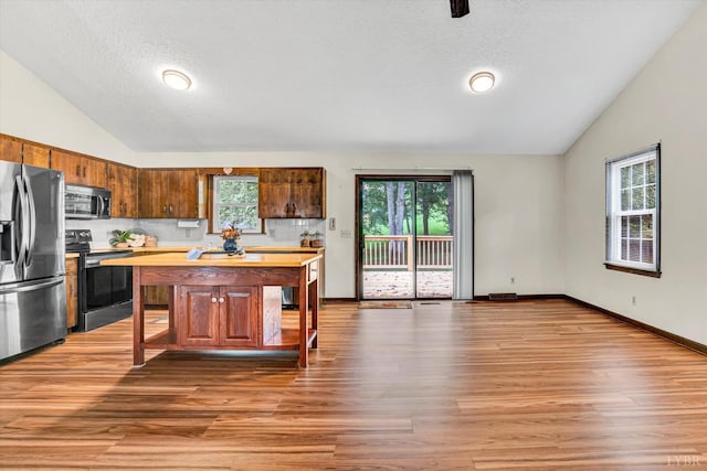 51 Laurel Ln, Lynchburg, VA 24502 - kitchen with appliances with stainless steel finishes, lofted ceiling, healthy amount of natural light, light wood-style flooring, and a textured ceiling