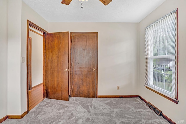 51 Laurel Ln, Lynchburg, VA 24502 - unfurnished bedroom featuring multiple windows, carpet flooring, a textured ceiling, and a ceiling fan