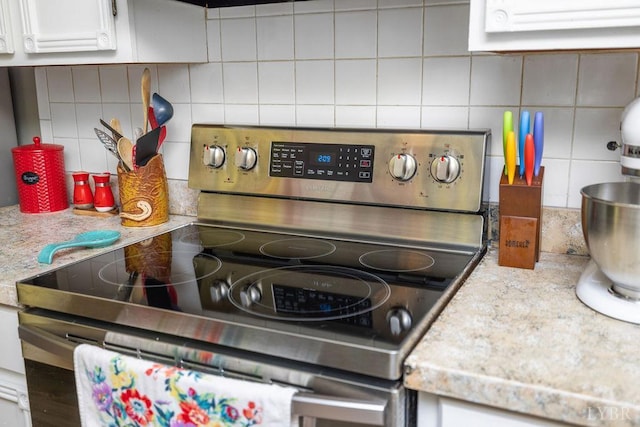 543 Dawnridge Dr, Lynchburg, VA 24502 - kitchen view of stainless steel electric stove, decorative backsplash, and white cabinets