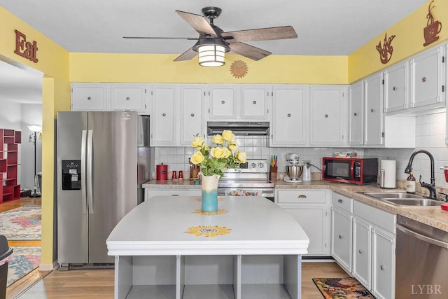 543 Dawnridge Dr, Lynchburg, VA 24502 - kitchen with appliances with stainless steel finishes, under cabinet range hood, light countertops, and white cabinets