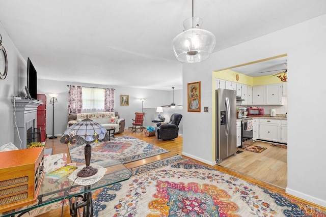 543 Dawnridge Dr, Lynchburg, VA 24502 - living room featuring light wood finished floors, a ceiling fan, and a fireplace