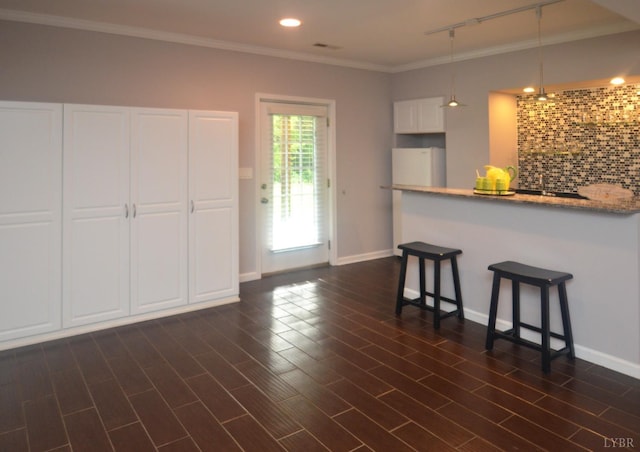 3600 Old Forest Rd Unit 113, Lynchburg, VA 24502 - kitchen with a breakfast bar, white cabinetry, crown molding, decorative backsplash, and hanging light fixtures