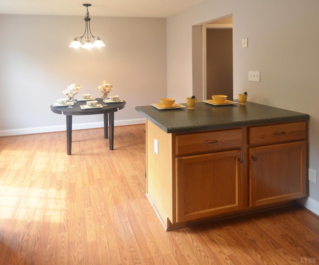 3600 Old Forest Rd Unit 113, Lynchburg, VA 24502 - kitchen with light wood-style flooring, dark countertops, decorative light fixtures, and a chandelier