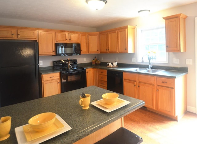 3600 Old Forest Rd Unit 113, Lynchburg, VA 24502 - kitchen with black appliances, dark countertops, light wood finished floors, and a breakfast bar