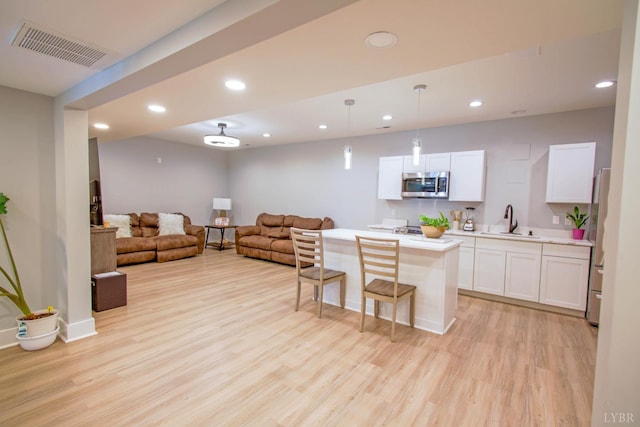 30 Patrick Ct, Madison Heights, VA 24572 - kitchen featuring stainless steel appliances, light wood-type flooring, light countertops, open floor plan, and a breakfast bar