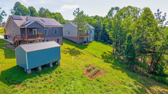 30 Patrick Ct, Madison Heights, VA 24572 - back of property with a yard, a wooden deck, an outdoor structure, and roof mounted solar panels