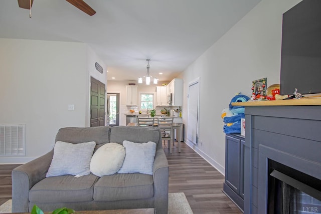 30 Patrick Ct, Madison Heights, VA 24572 - living area with dark wood-style floors, recessed lighting, a fireplace, a ceiling fan, and a chandelier