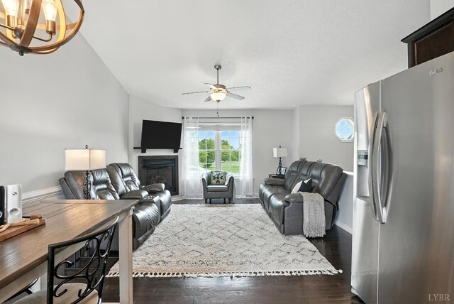4086 Thomas Jefferson Rd, Forest, VA 24551 - living room with a glass covered fireplace, dark wood-type flooring, ceiling fan, and a chandelier
