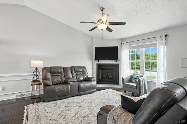 4086 Thomas Jefferson Rd, Forest, VA 24551 - living room featuring a ceiling fan, dark wood-type flooring, a fireplace, and vaulted ceiling