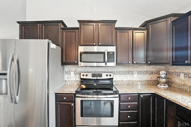 4086 Thomas Jefferson Rd, Forest, VA 24551 - kitchen with stainless steel appliances, backsplash, dark brown cabinets, and light stone countertops